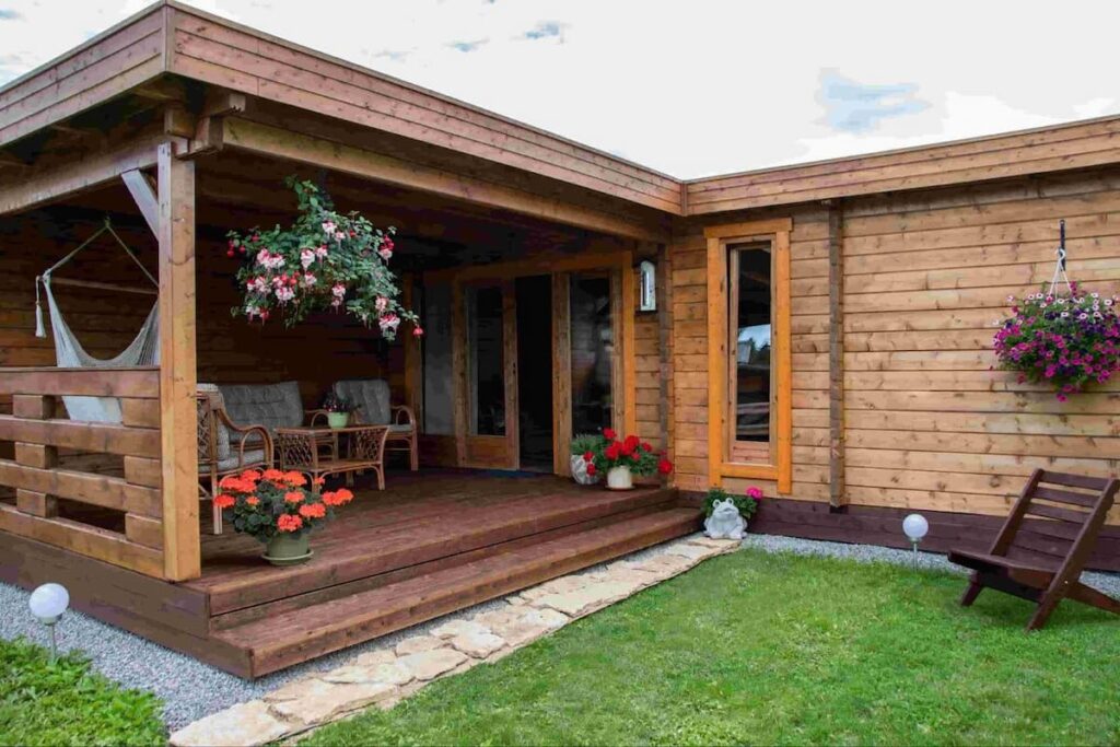 a wooden garden house with a porch