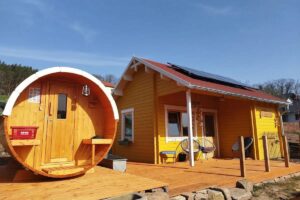 garden shed and sauna barrel in warm yellow