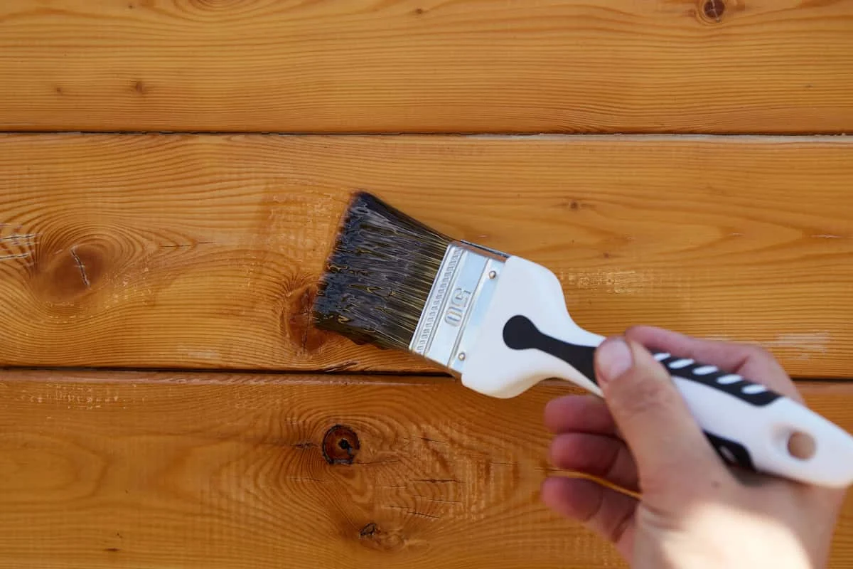 Applying wood stain with a brush